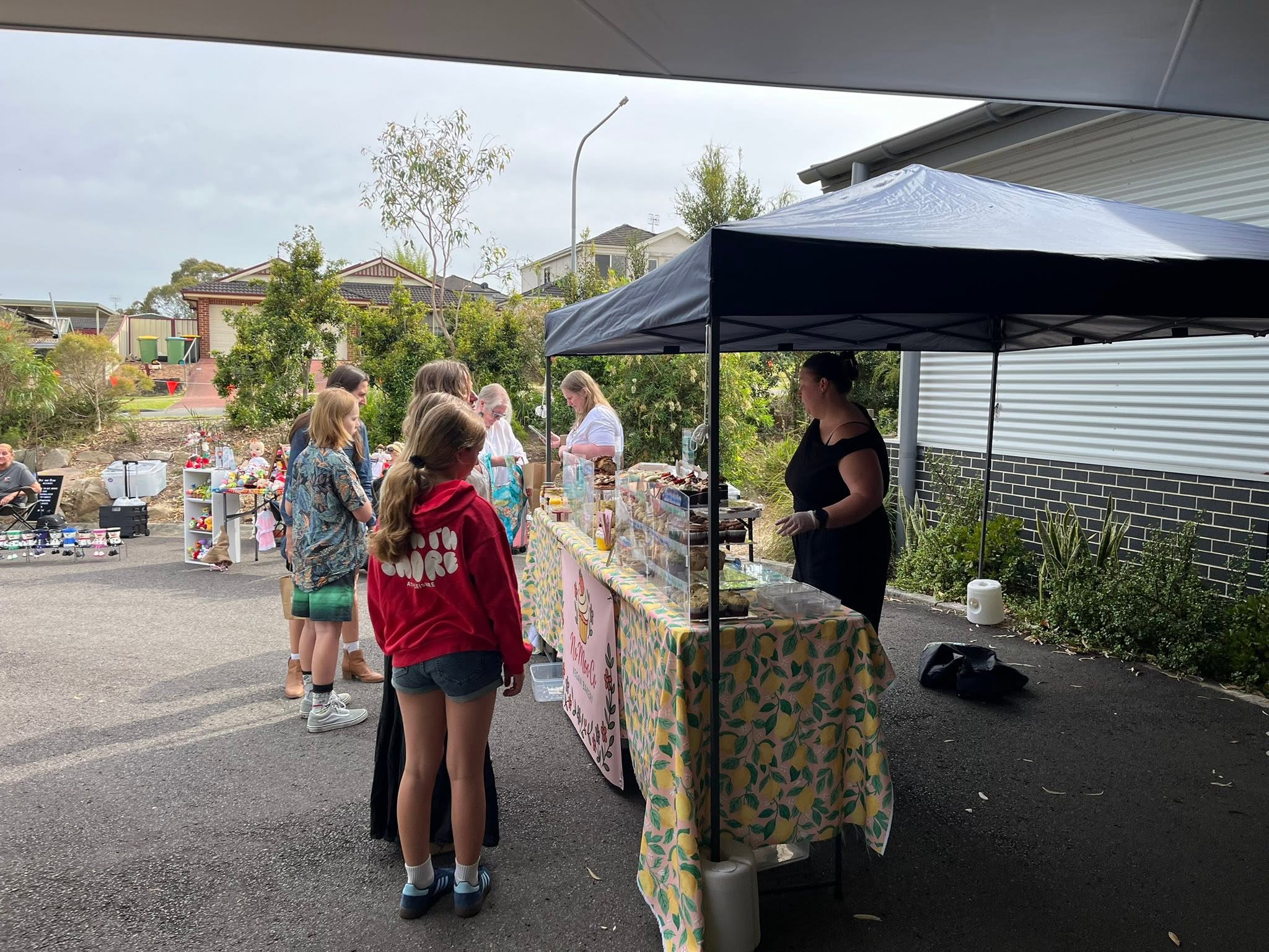 Visitors browsing an outdoor market stall